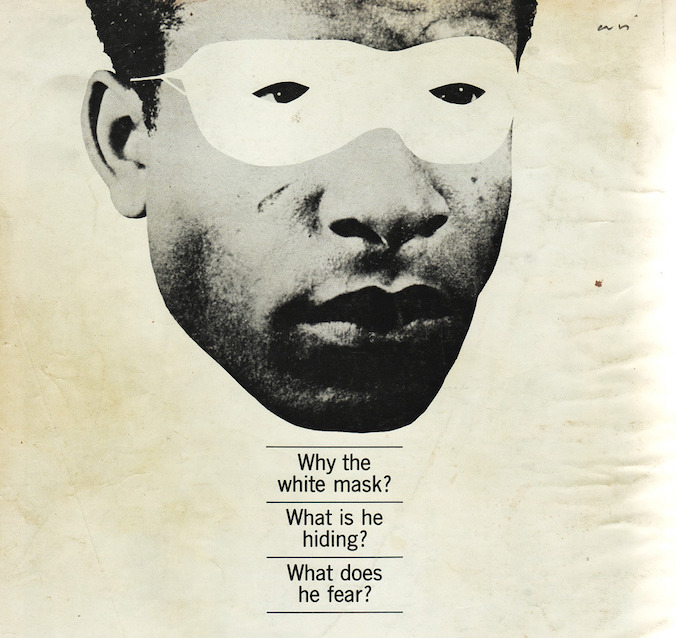 The photo shows a black and white photograph of Frantz Fanon with a white blindfold. The photo features a caption saying Why the mask? What is he hiding? What does he fear?